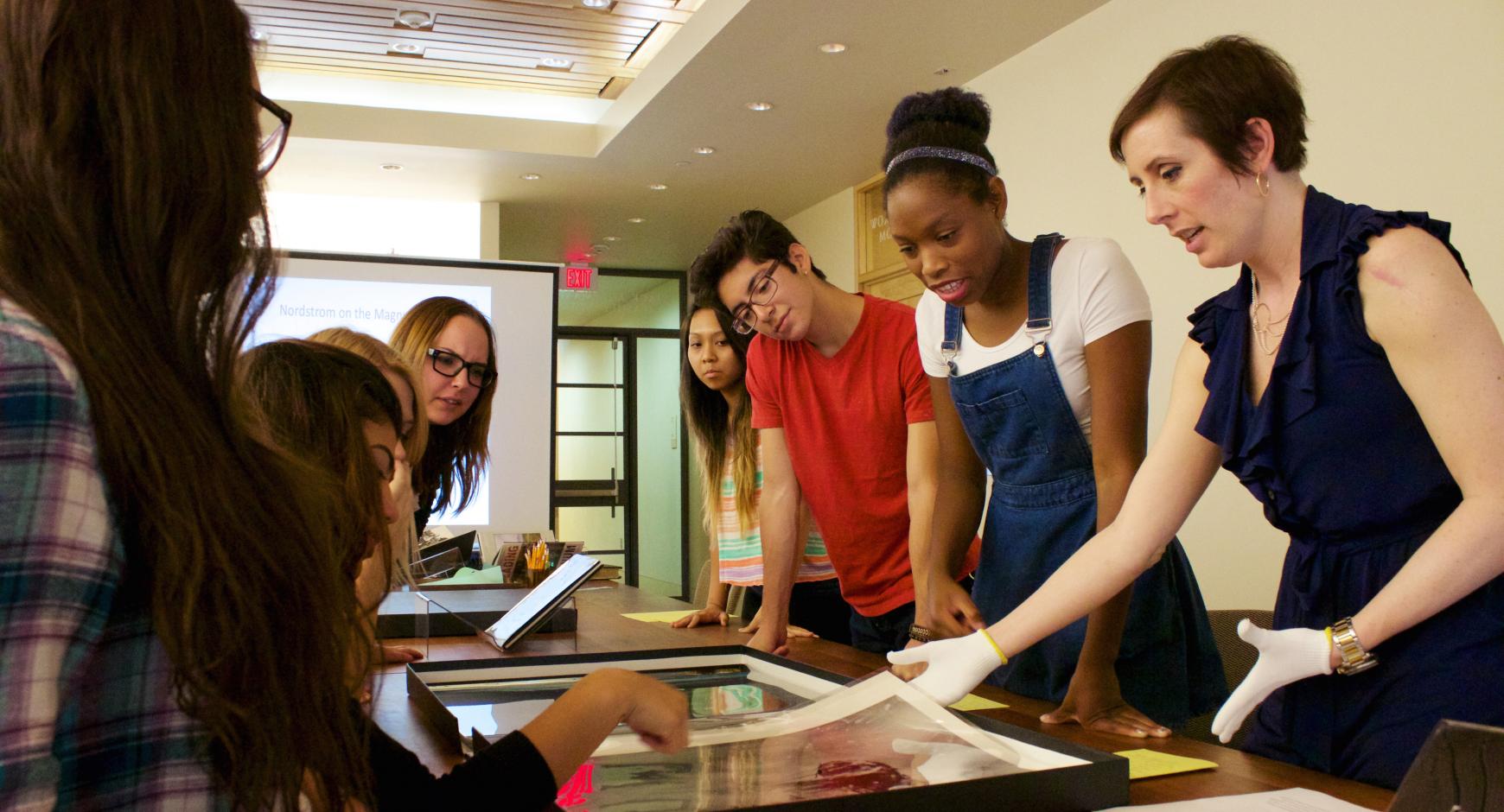 Students examine archival photos at the Harry Ransom Center