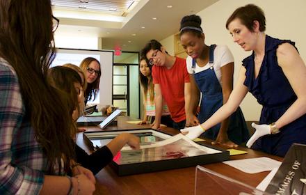 Student researchers examine object.